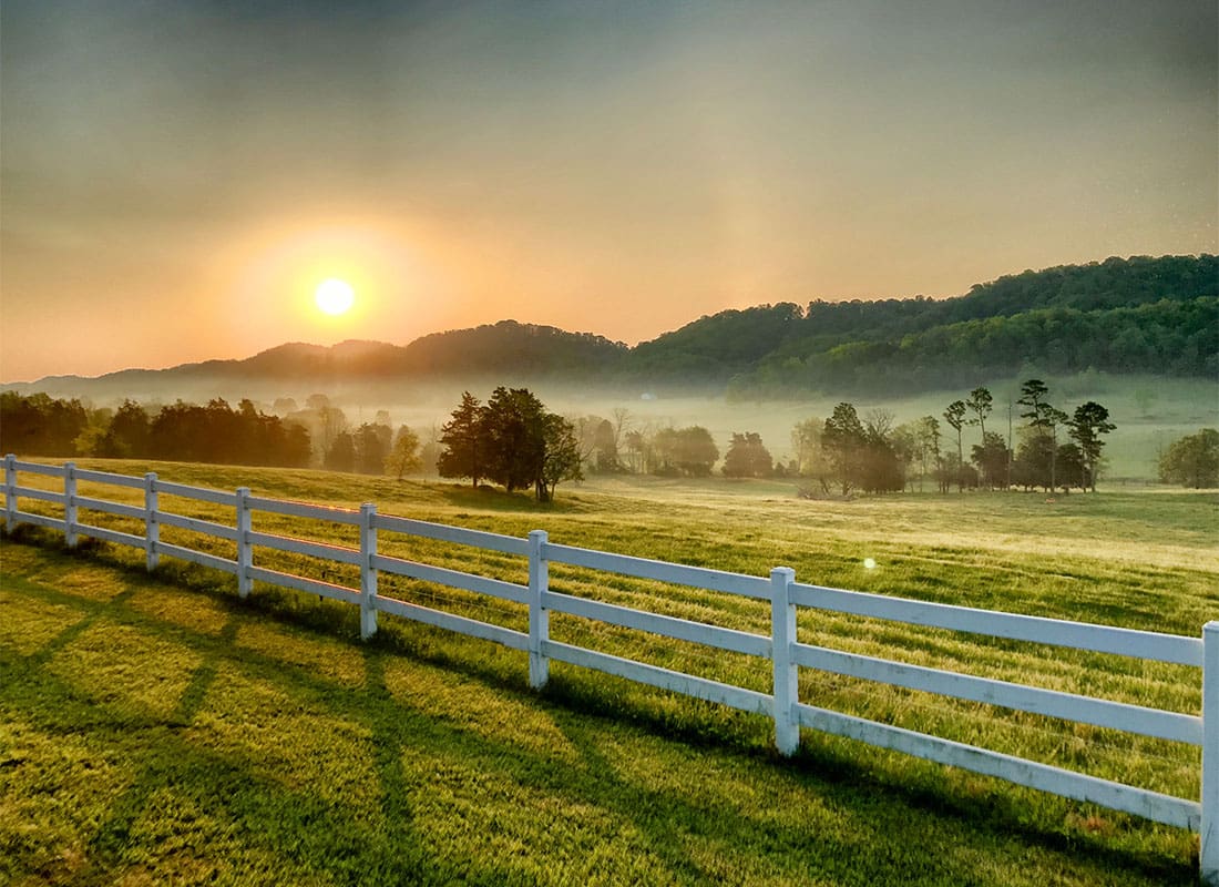 Cordova, TN - Scenic View of a Farm with a White Picket Fence at Sunset in Rural Cordova Tennessee